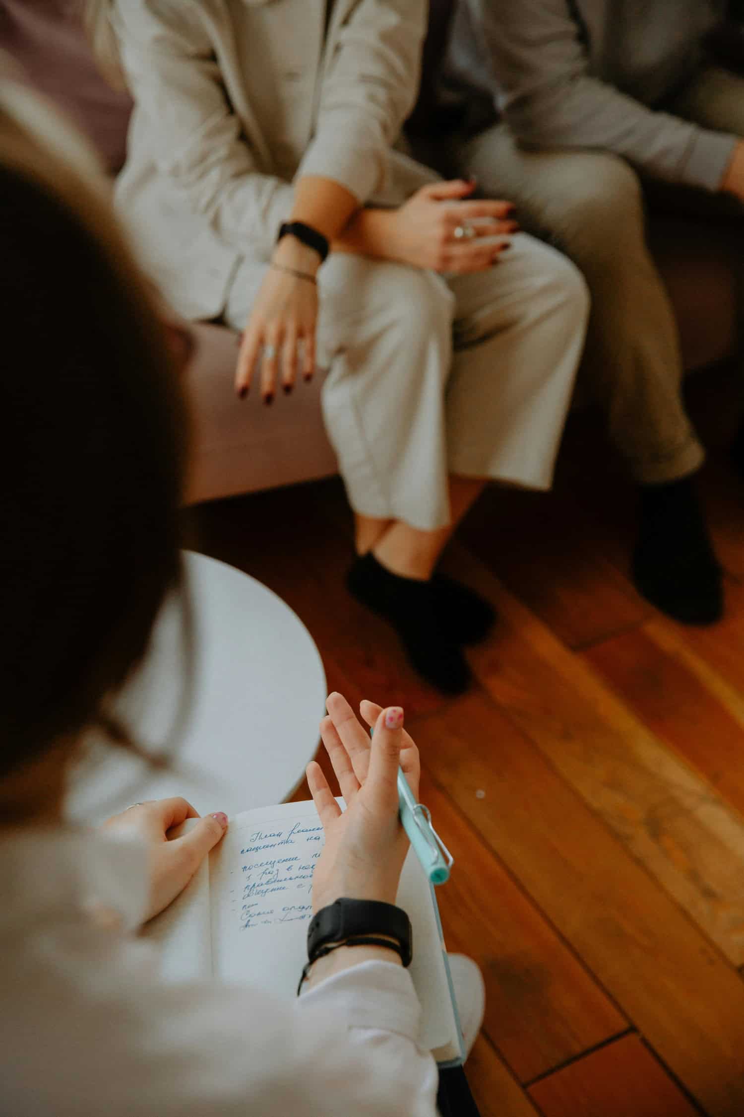 Psychologist facilitating a supportive group therapy session focused on mental health and emotional wellbeing